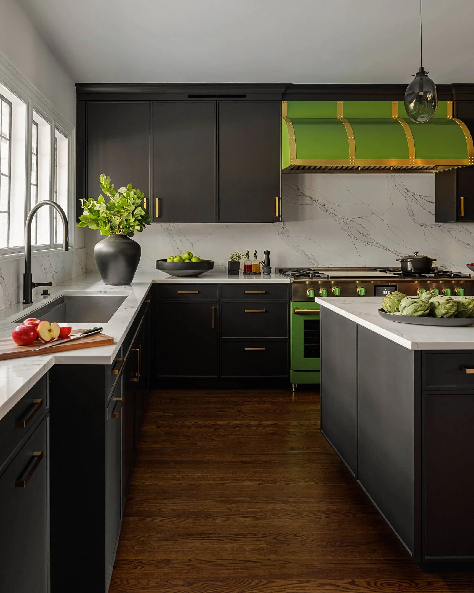 Black Kitchen with Green range and hood