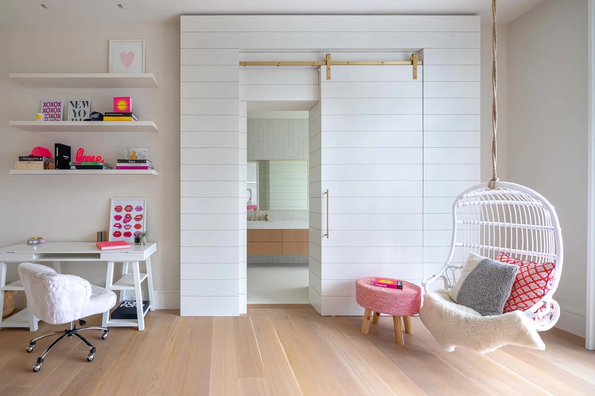girls room with work space and having chair, barn door to bathroom