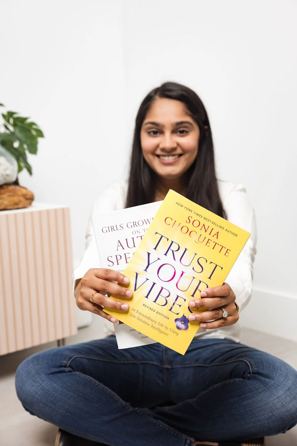 Shivani Solanki holding Trust Your Vibe book for South Asian mental health therapy in Texas