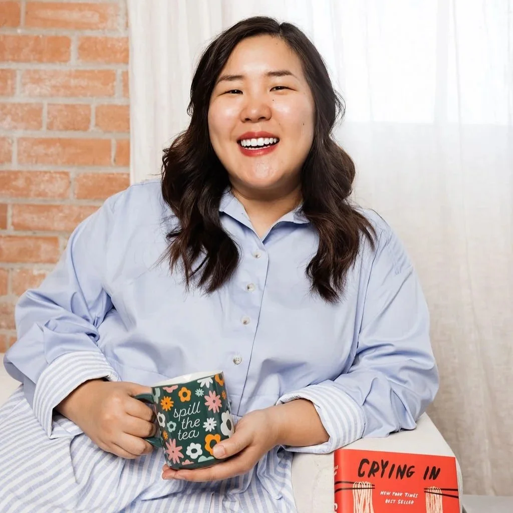 A mental health therapist smiling whiling holding a mug