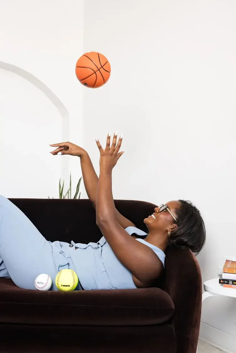 Peyton Stokes Sutton throwing a basketball. She offers therapy to athletes in Indiana and Texas