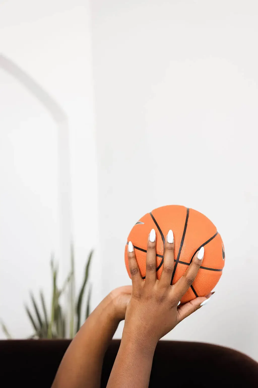Peyton Sutton Stokes holding a basketball. She provides sports therapy in Dallas, Texas