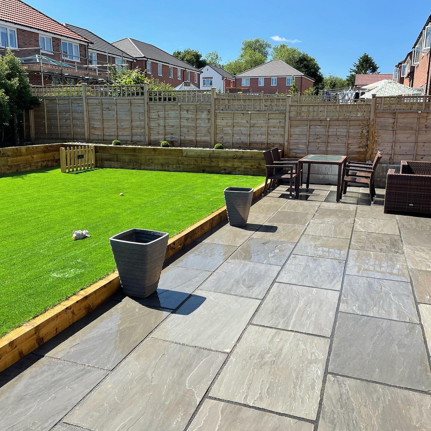 Complete garden reconstruction, with Kandla Grey Indian Sandstone, artificial grass, and railway sleeper box hedges/ retention. Bramble Drive, Harrogate