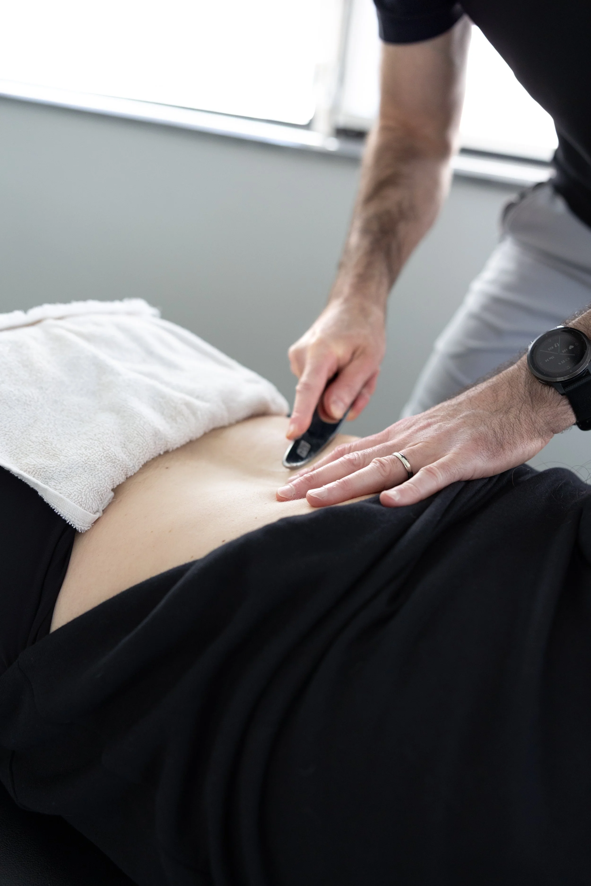 Dr. Bryan Abrams performing Graston Technique instrument-assisted soft tissue treatment on a patient at Healing Motion.