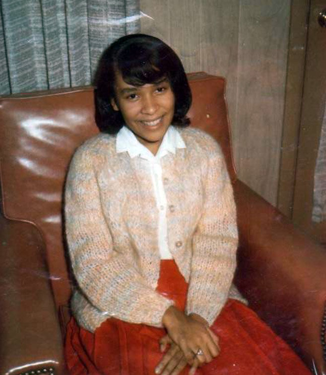 Mrs. Draper at fifteen. Shy and studious. That's a mohair sweater--all the rage at the time. EVERYBODY had one. Even then I liked bright colors.