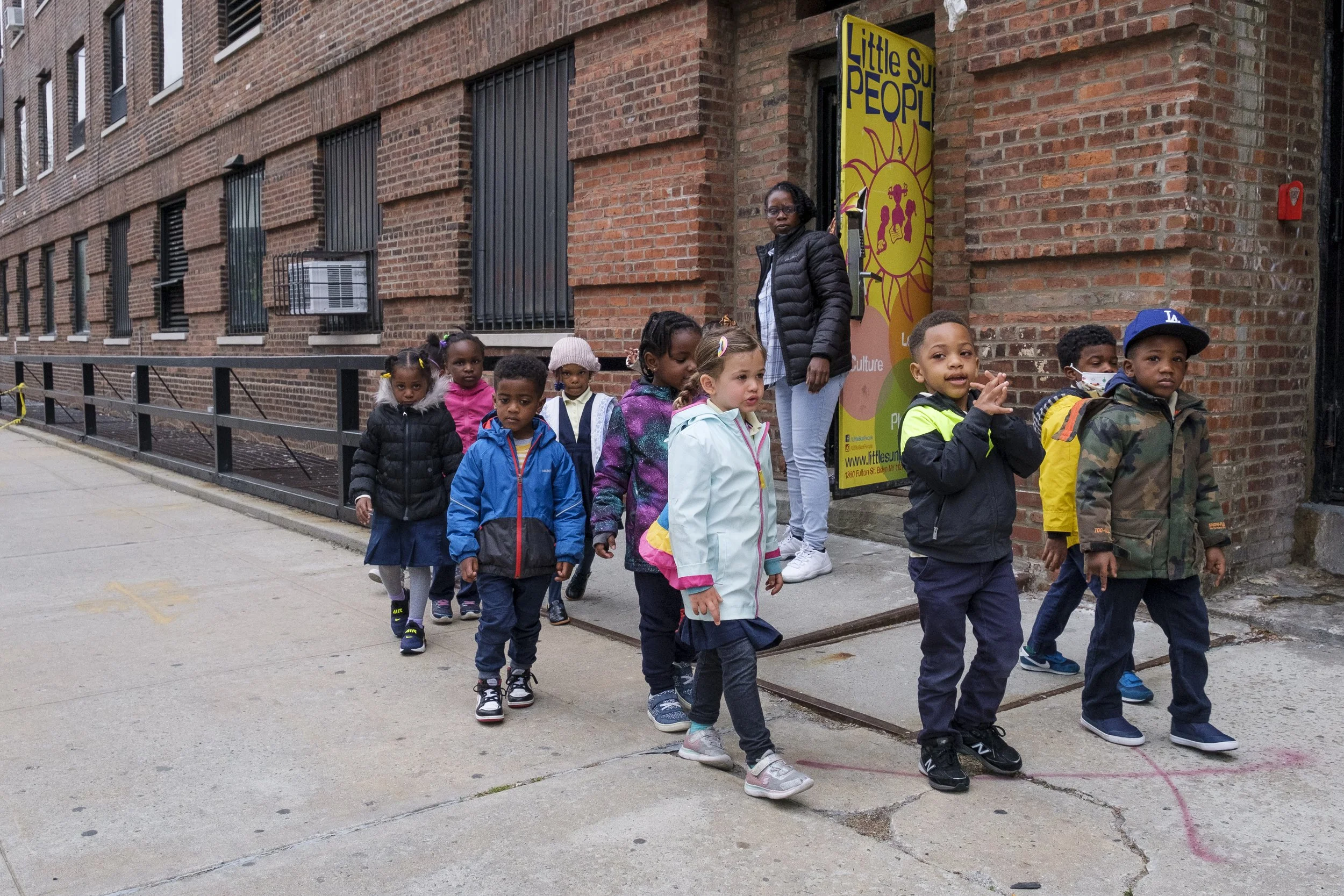  Students from Little Sun People’s Ife Threes class exit the school building on April 26, 2022. ©Henry Danner, 2022, All Rights Reserved 