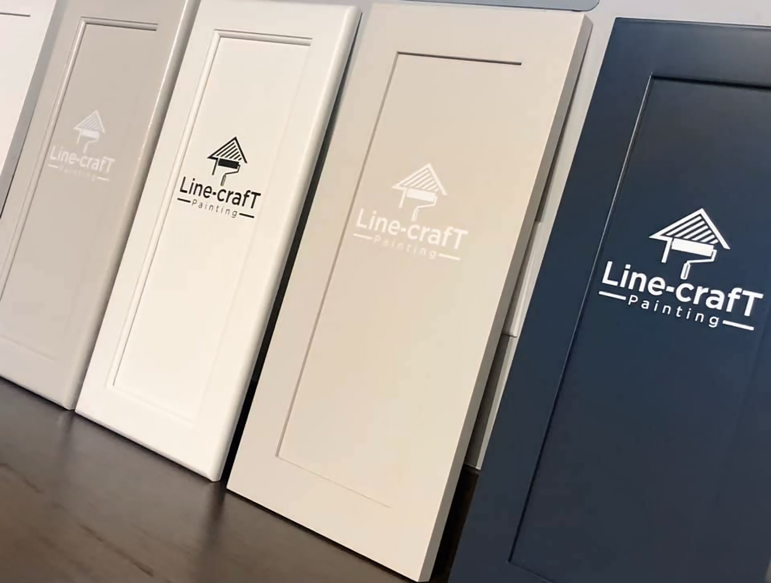 A display of four cabinet doors in different colors, each with a 'Line-craft Painting' logo, arranged from left to right: light beige, off-white, white, and dark blue.