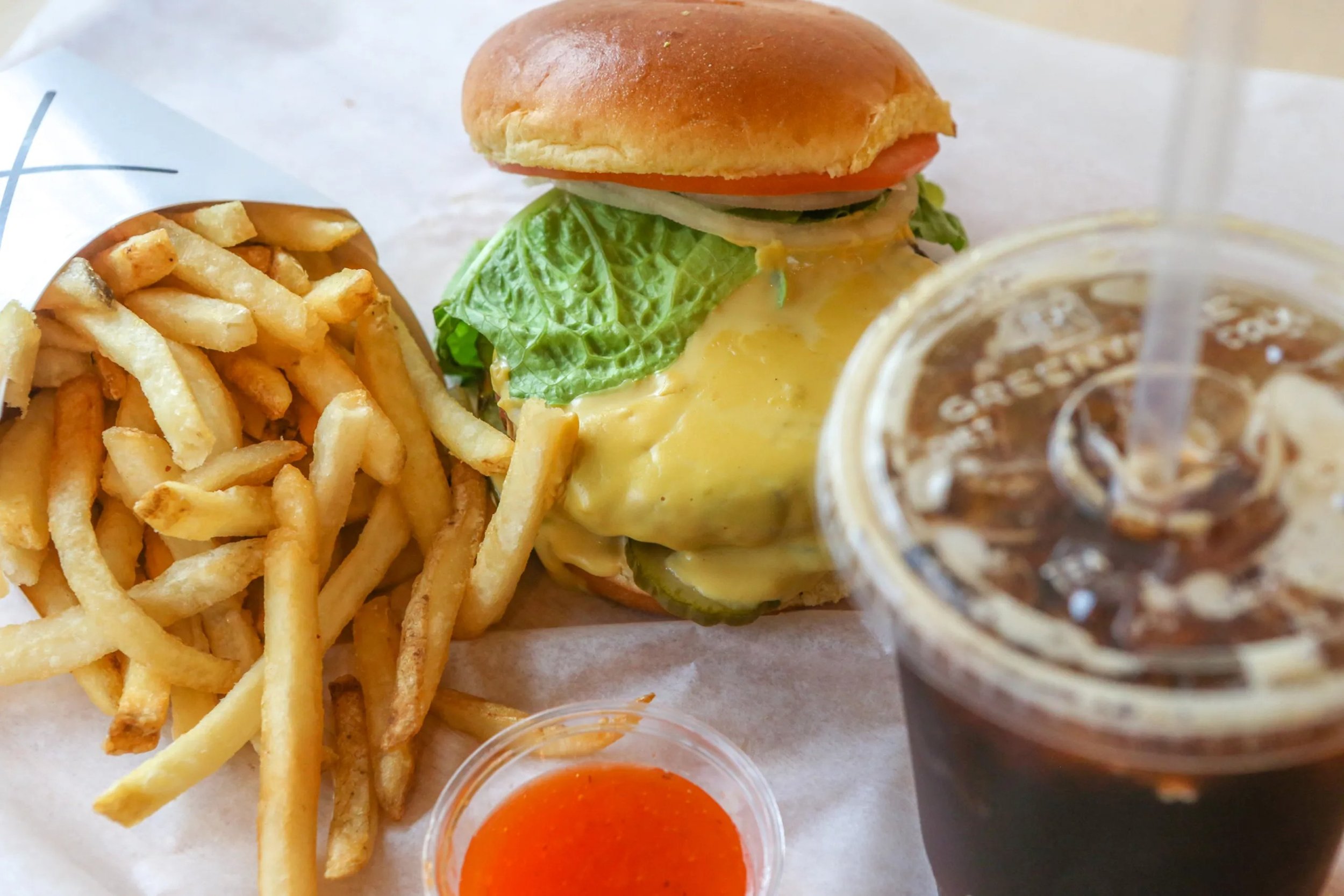  The X Burger can be enjoyed with the restaurant's signature bean, vegetable and grain patty or an Impossible Burger. It's topped with cashew cheddar sauce. Tractor Beverage Co. soda, an organic drink that comes in many flavors, including cola and ro