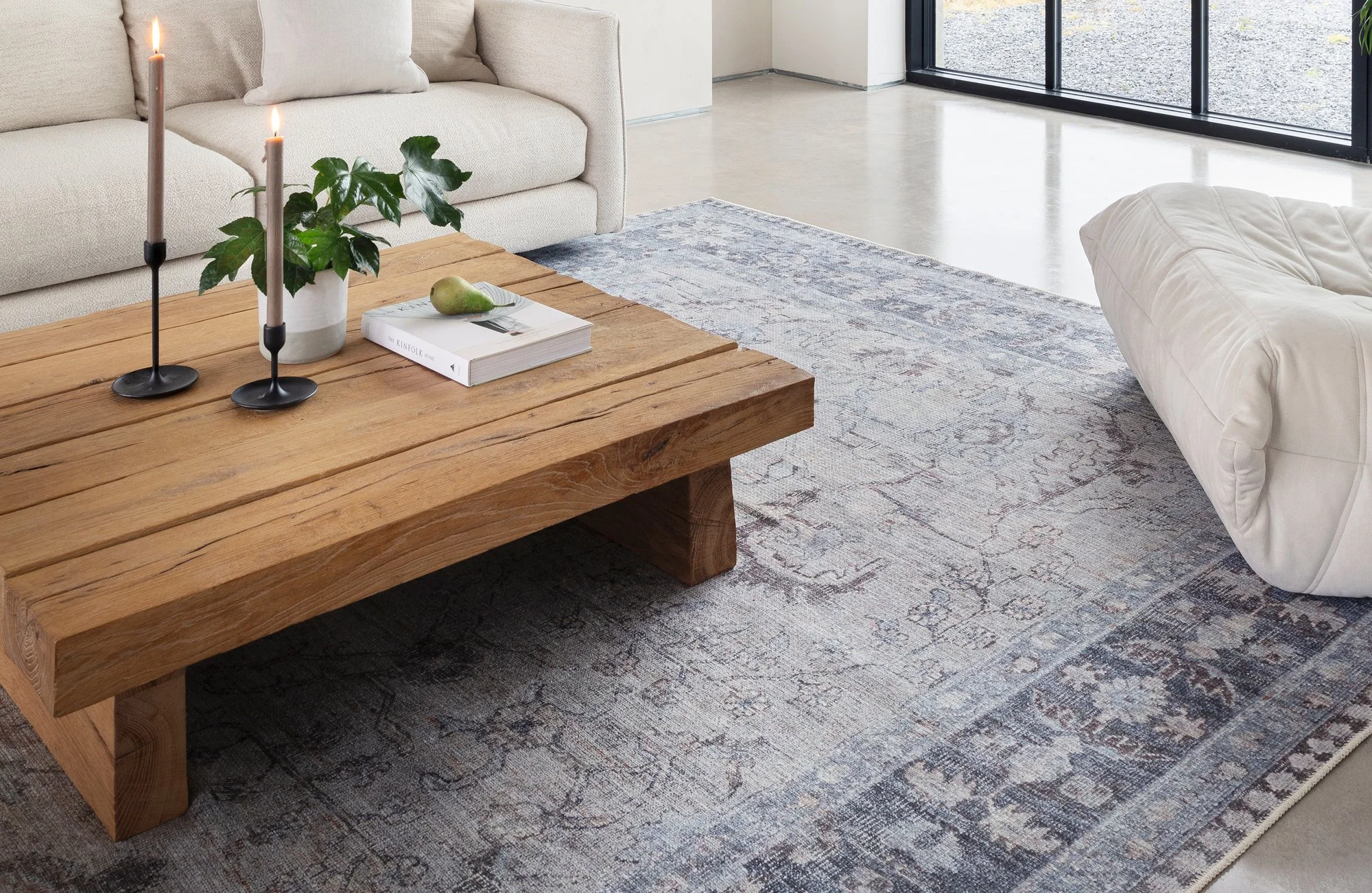 rustic coffee table on a stylish blue rug
