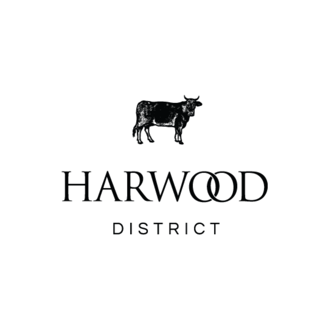 Graphic of a cow silhouette above the text 'HARWOOD DISTRICT'.