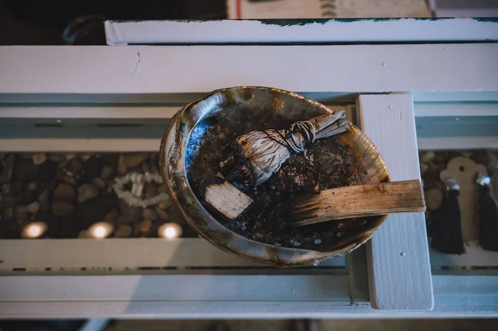 Burning Sage in an Abalone Shell in Wasaga Beach Yoga's Welcome area.
