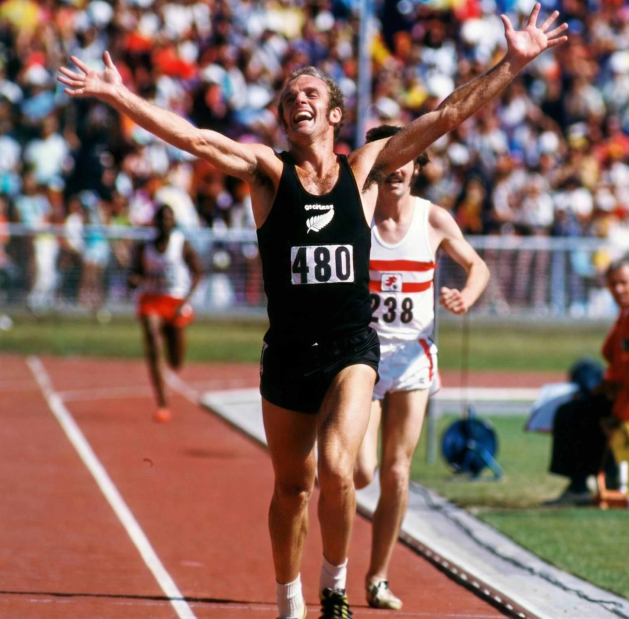 Dick Taylor celebrates his 10,000 meter Gold Medal