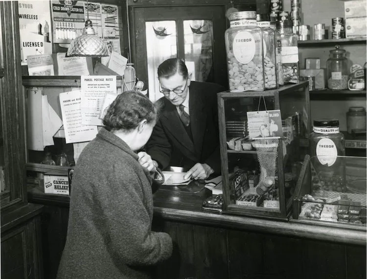 Black ad white vintage photo of a woman at the post office