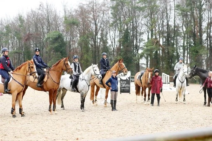 a group of people riding horses