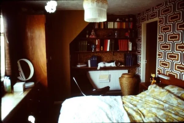 bedroom with wooden furniture and wallpaper