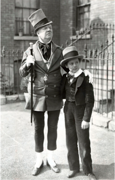 black and white photo of Mr Micawber and a kid