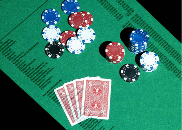 poker table with chips and 4 cards