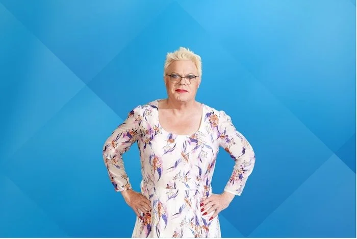 Eddie Izzard on blue background