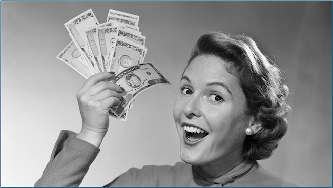 black and white photo of a woman holding a fan of dollars