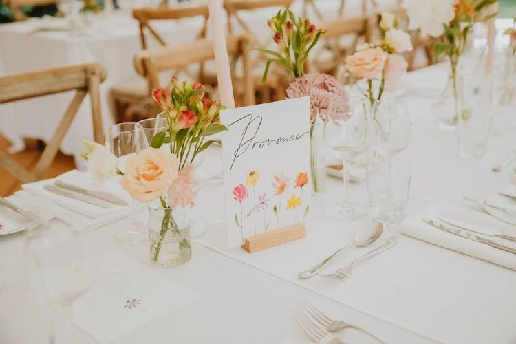 colourful wedding table with flowers in bud vases