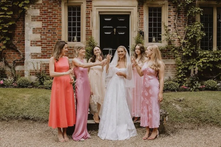 colourful bridesmaids toasting to the bride