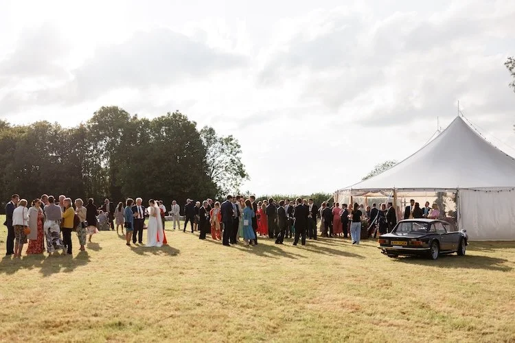 wedding guests gathering outside the marquee in somerset
