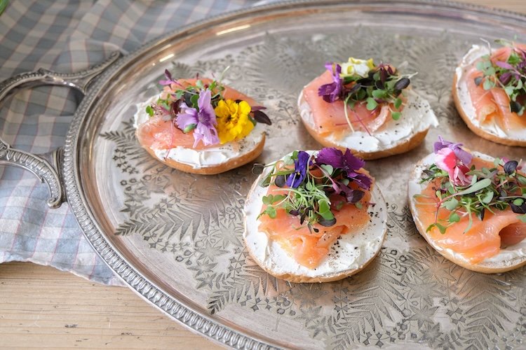 smoked salmon bagels with edible flowers by wild fork west