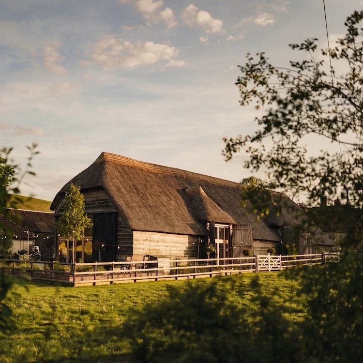 An image of Bowerchalke Barn's main barn in the countryside