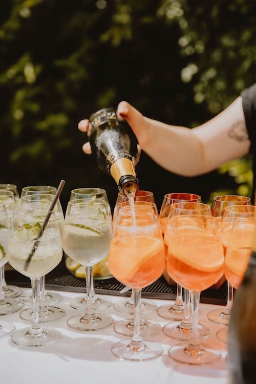 Wild Fork's wedding team serving aperol spritz and hugo spritz