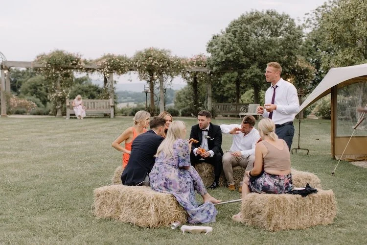 Wedding guests at euridge manor on hay bales