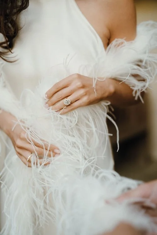A bride wearing a vintage feather boa at Euridge Manor