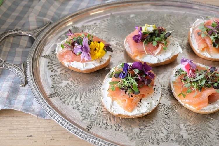 Colourful corporate brunch catering by Wild Fork with smoked salmon bagels on a tray