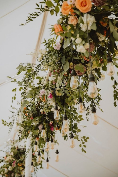 colourful floral installation in a marquee
