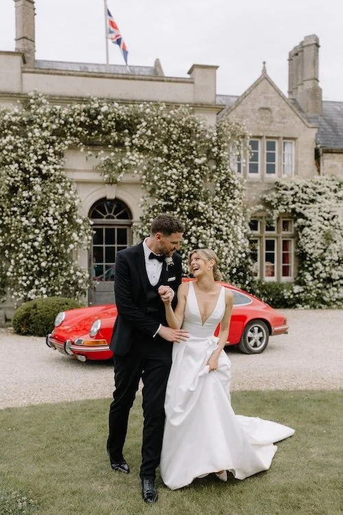 wild fork west catered a beautiful euridge wedding with a couple stood in front of a vintage car
