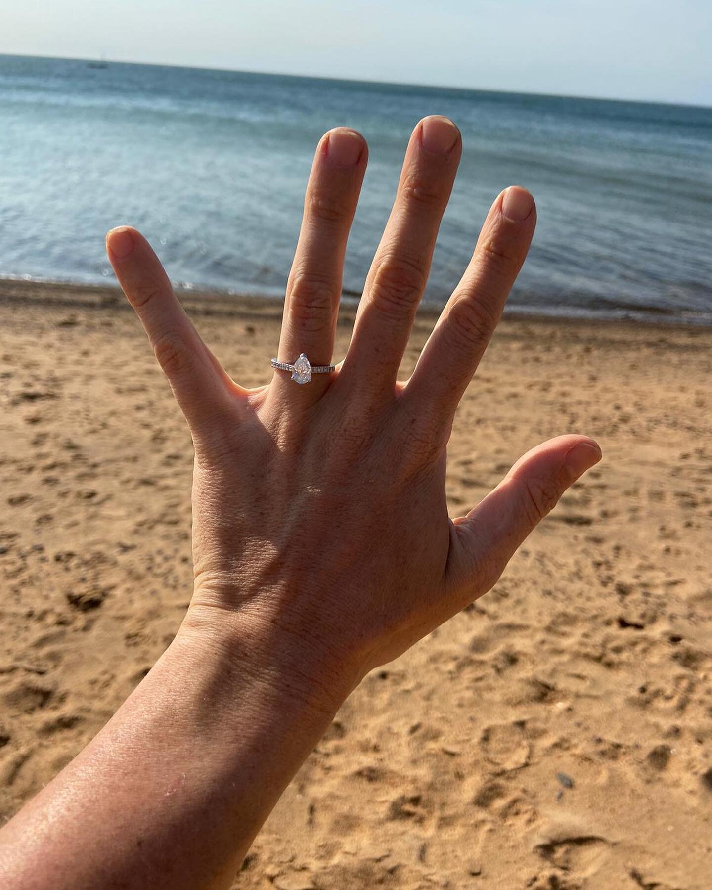 A very happy snap of Meg&rsquo;s pear cut diamond engagement ring after Tom surprised her with a romantic proposal at their favourite beach spot 💕 It was such a privilege to design this gorgeous ring and play a part in this very special moment. #eng