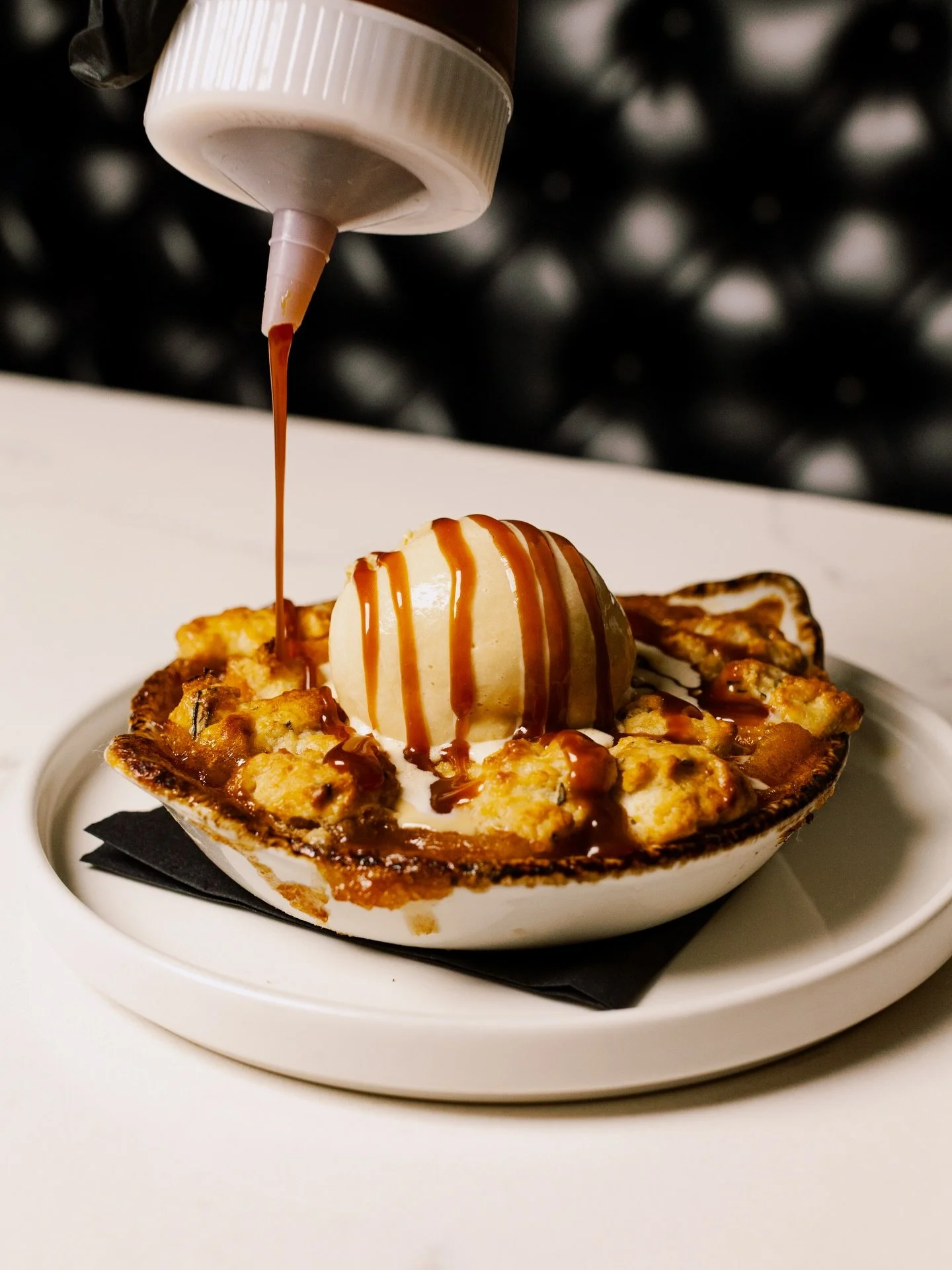 Bourbon Caramel Peach Cobbler

Rosemary Biscuit, Salted Caramel Ice Cream

Shot for @signaturesteak 

Always a sucker for posting a carousel of images, especially when you get to show process.

Caramel drizzle (1)
Final presentation (2)
Picture perfe