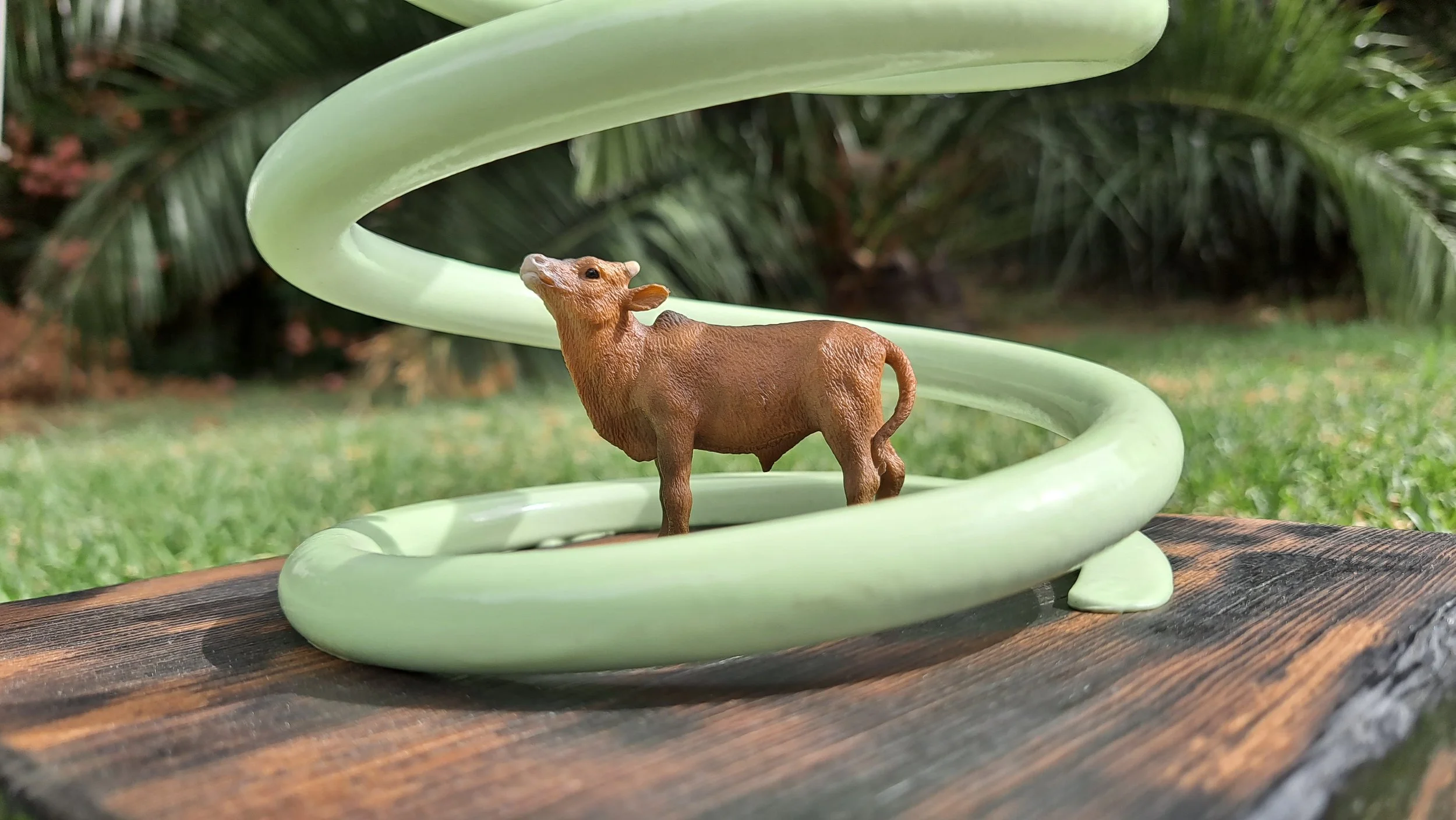 scrap metal flying saucer abducting a toy cow