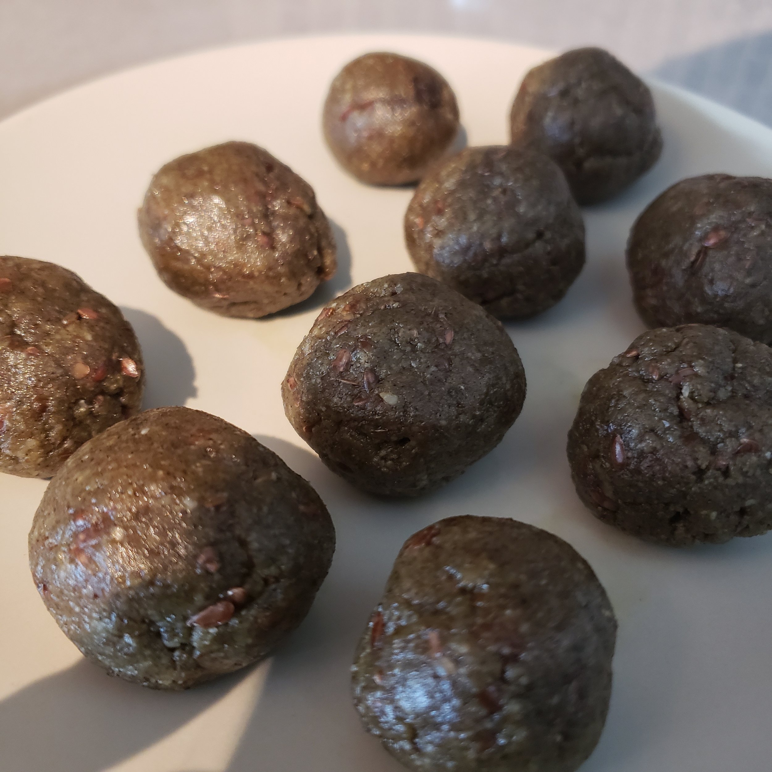 Balls from the freezer before rolling into the coconut