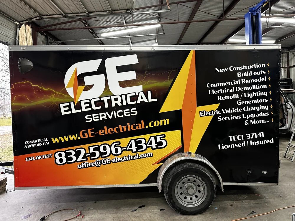 GE Electrical Services trailer with contact information and services listed on the side, including new construction, build outs, commercial remodel, electrical demolition, retrofit/lighting, generators, electric vehicle charging, and service upgrades