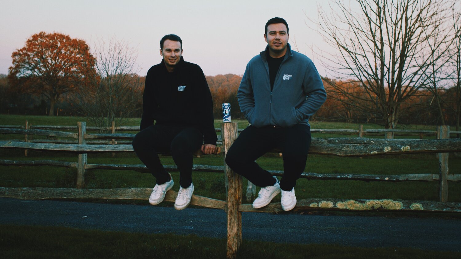 The two brother founders of Arrowtown hard seltzer, Rob and James Smith, sit in the Sussex countryside