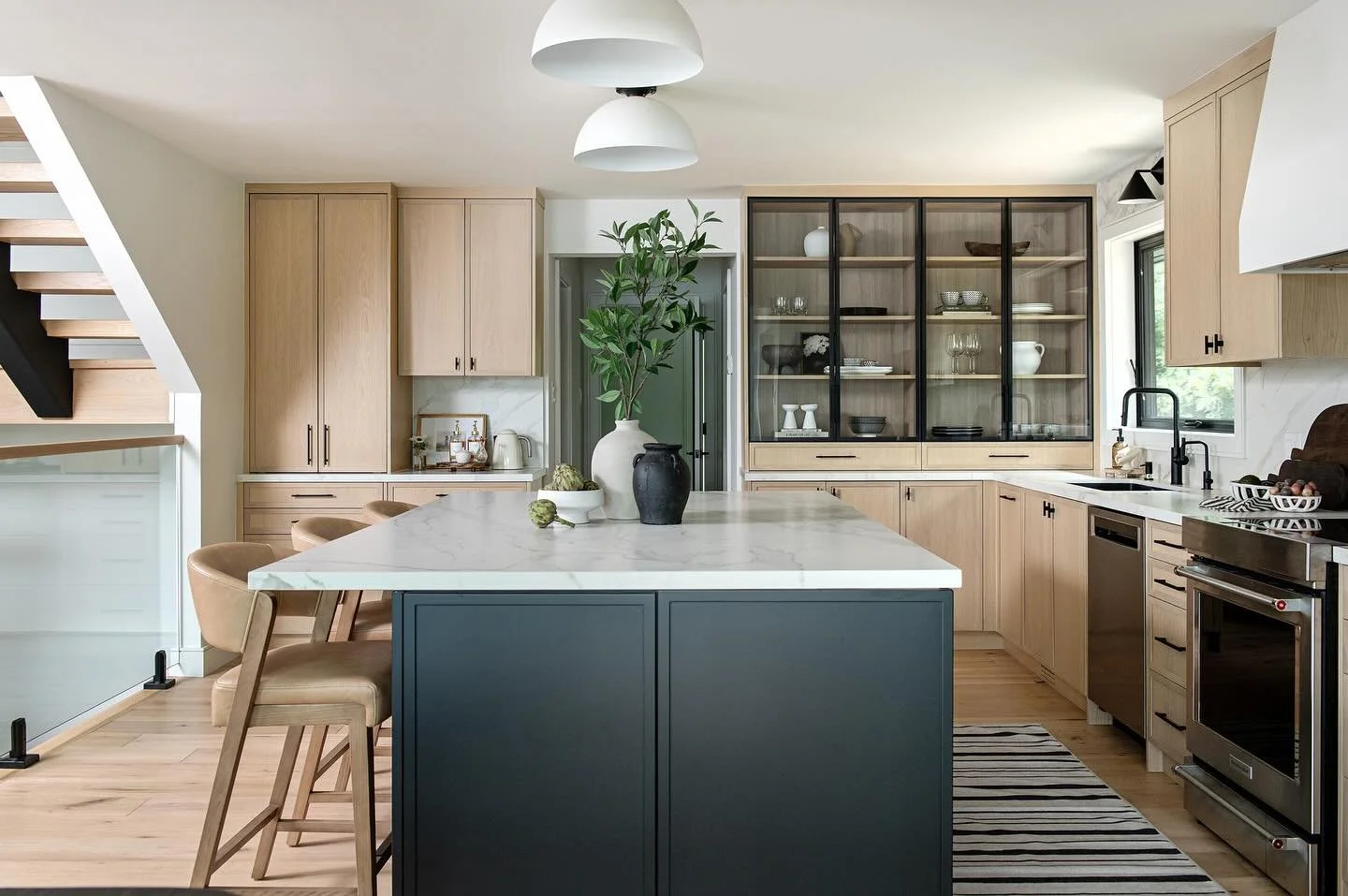 Where to start with what I love most about this custom kitchen we designed for our client&hellip;
The warm wood cabinetry? The black metal showcase cabinet? The coffee bar? That dark, moody island? Or the seriously cool pendant lights?
Every detail w