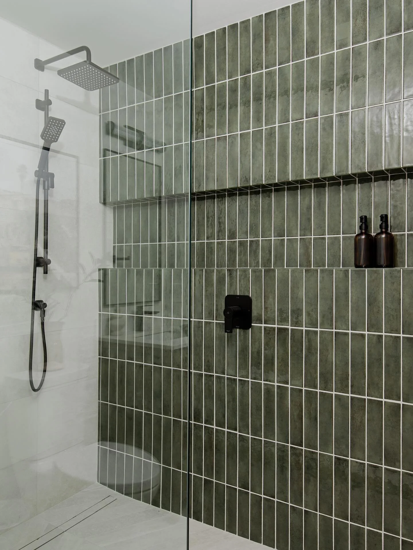 Inspired by nature, grounded in style. It&rsquo;s the green tile that steals the show for me 💚

Check out the before ⬅️ 

📸 @mike_chajecki 
🛠️ @hartley_built 

#DesignerBathroom
#LuxuryBathroom
#BathroomDesign
#ModernBathroom
#BathroomInspo
#Bathr