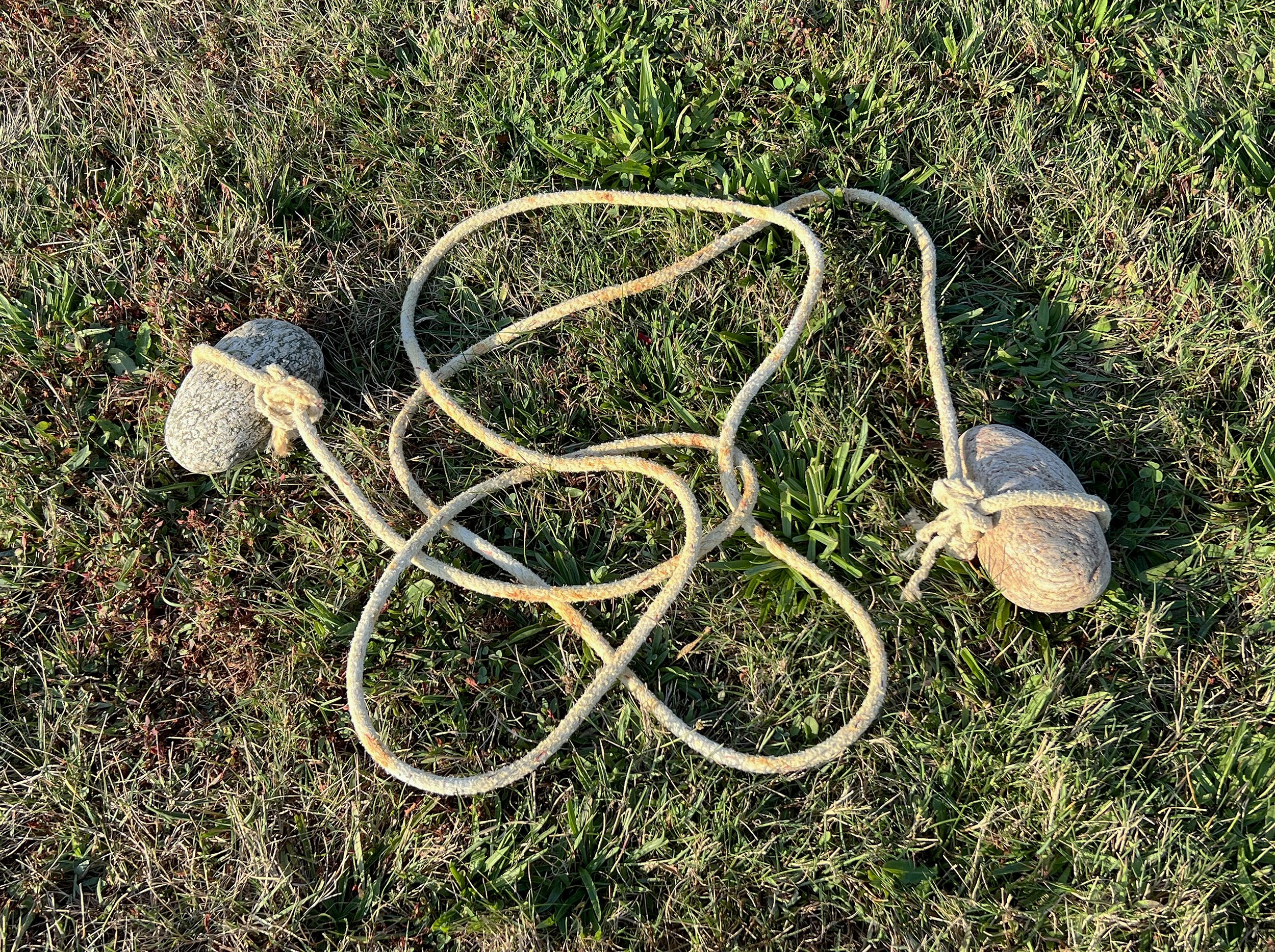 Rudimentary measuring tool I created using found fishing rope and two beach rocks.