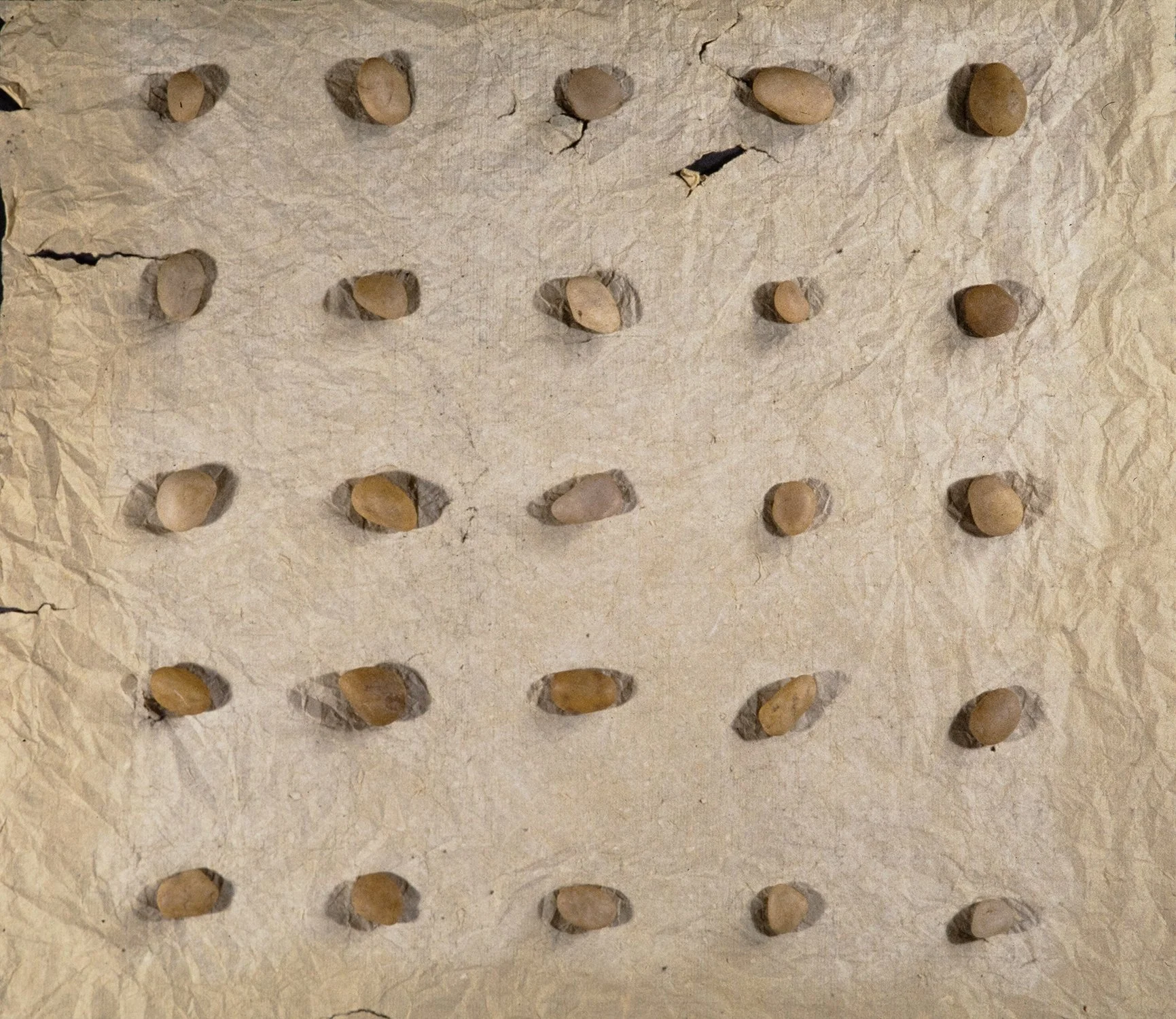 Matthew Deleget, 25 Stone Grid, 1995, Pencil, chalk, and stones on Japanese Kozo paper, 17 x 16 x 1 inches