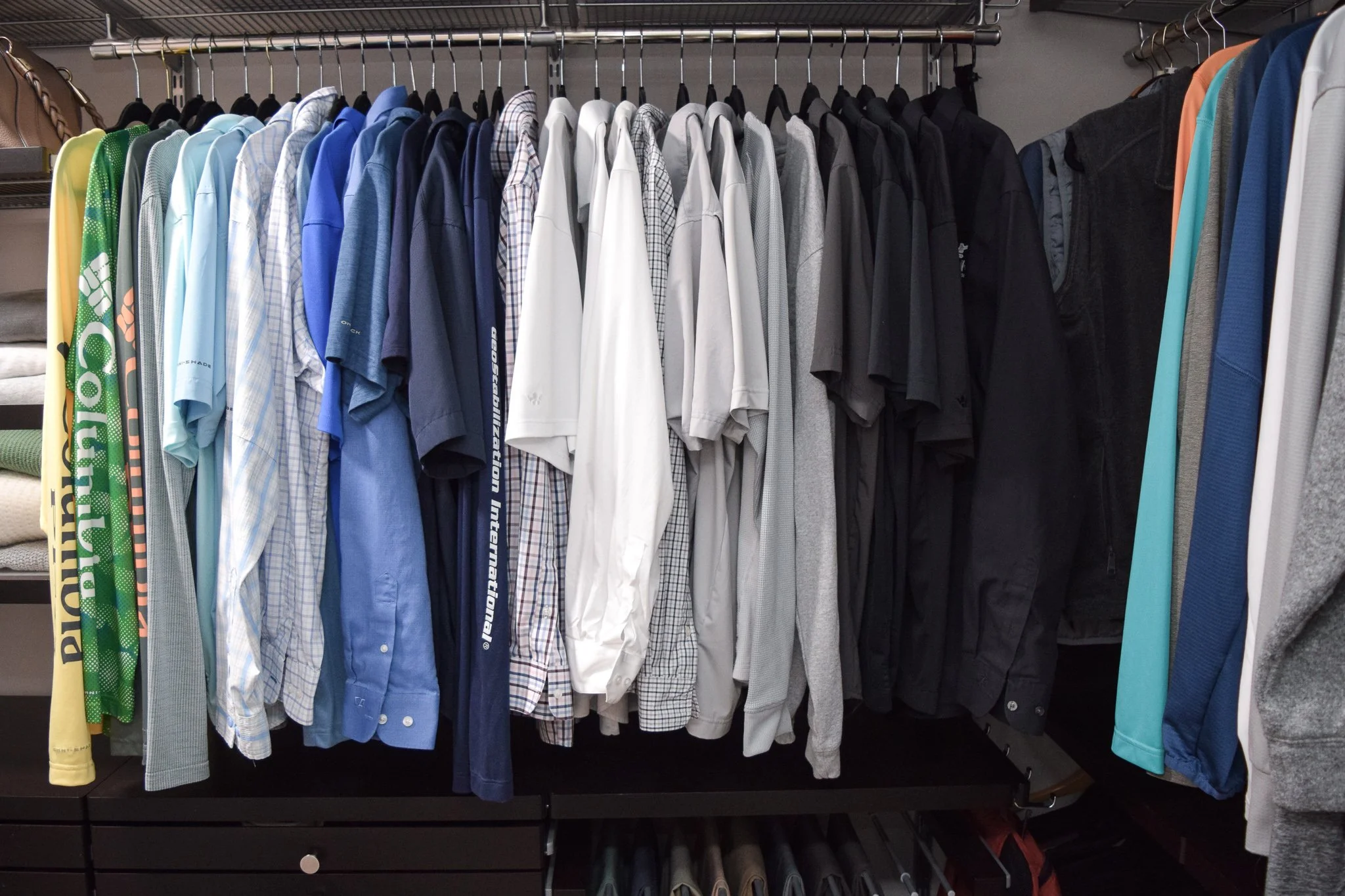 His shirts organized in color order - closet organization