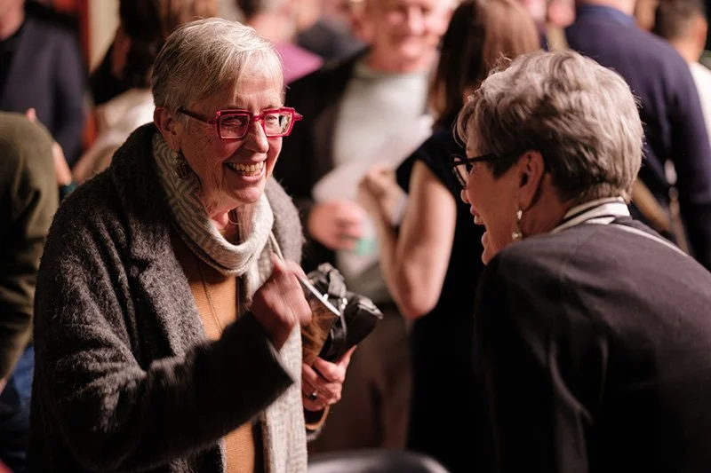 Photo of 2 audience members after a concert
