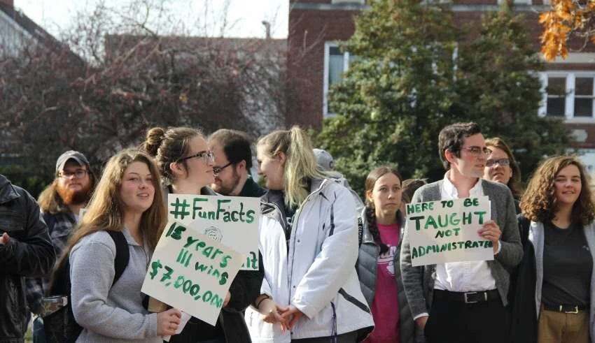 Several protesters held hand-painted signs. Photo by Sarah Donaldson.