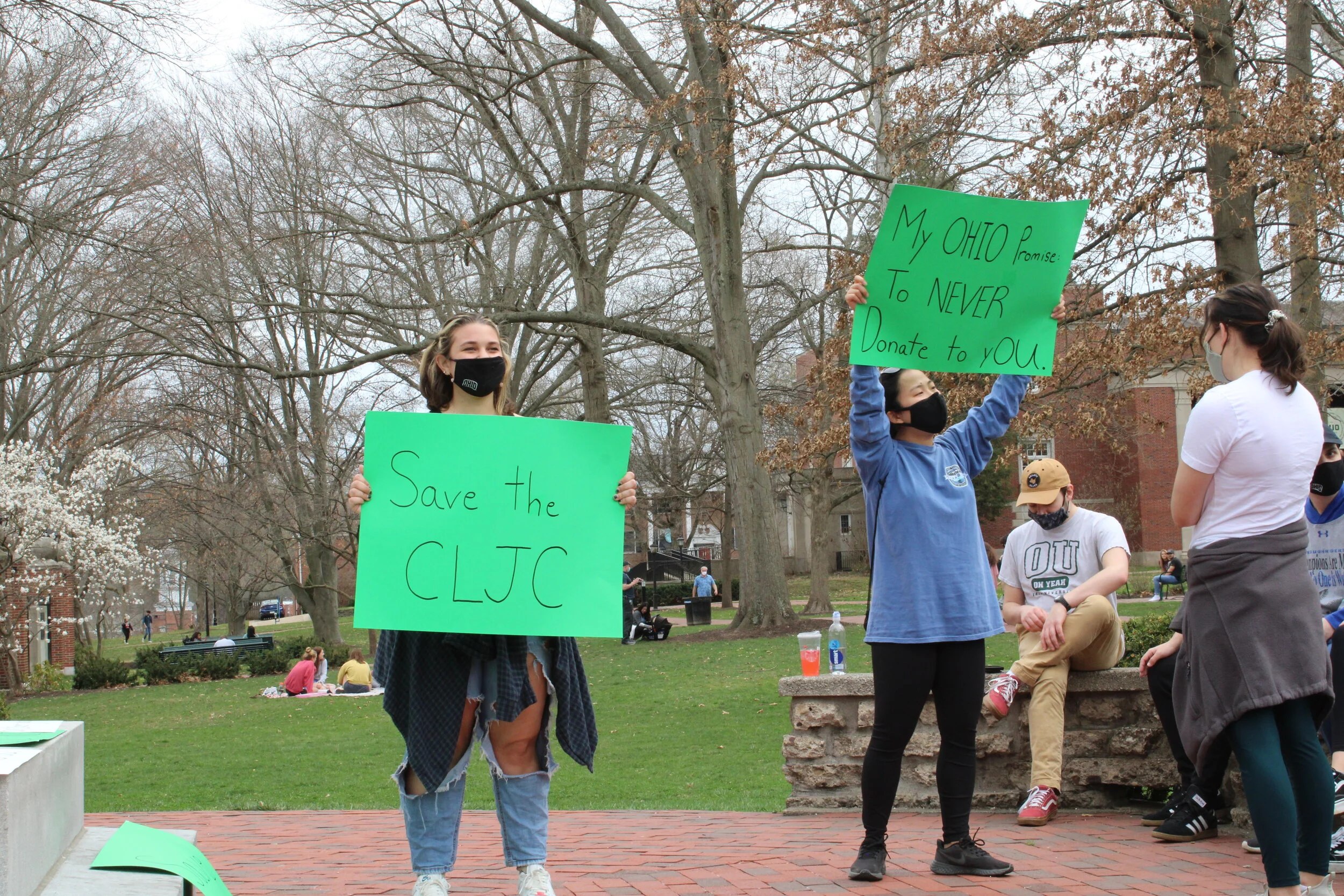    Students hold signs in support of the Center for Law, Justice and Culture on College Green. Photo by Emily Crebs.   