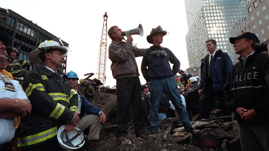 “President George W Bush rallies firefighters and rescue workers during an impromptu speech at the site of the collapsed World Trade Center” Photo courtesy of the Smith Collection/Gado/Getty Images