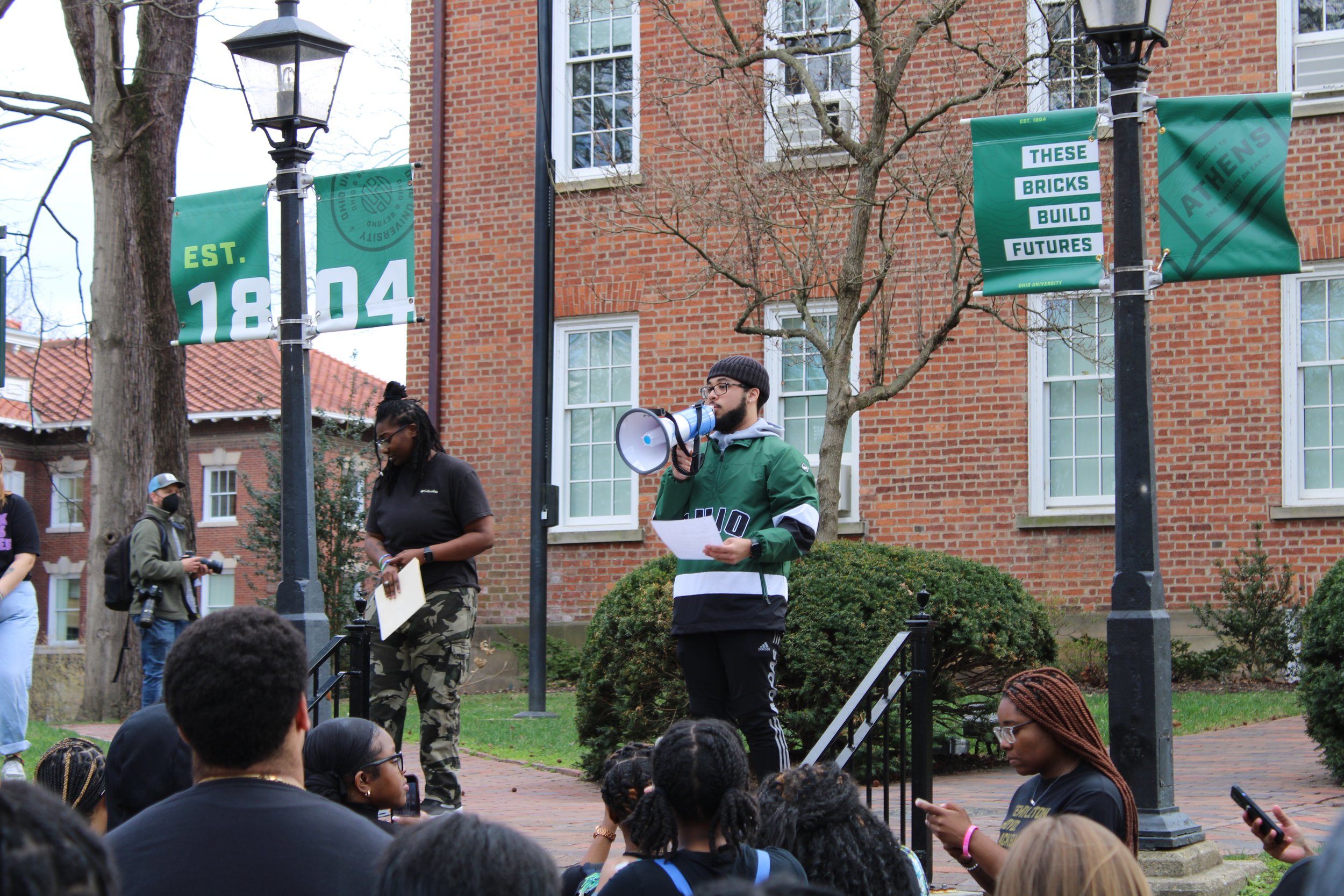  Former James Hall Resident Advisor Christopher Brown speaks to protesters in front of Cutler Hall. Photo by Izzy Keller. 